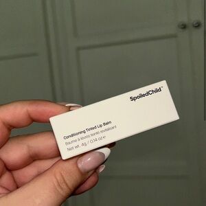 NEW, unopened, Spoiled Child conditioning tinted lip balm. Plum color